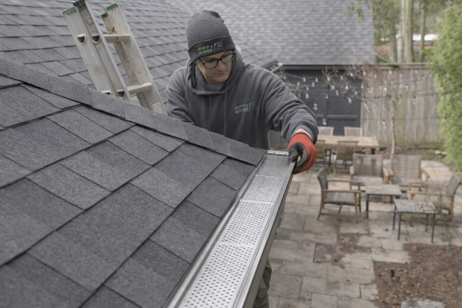 Technician installing eavestrough gutter guard system on residential home in Toronto showing professional leaf filter gutter installation
