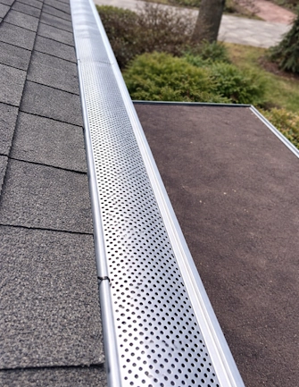 Stainless steel gutter screen installation on a residential roof in North York